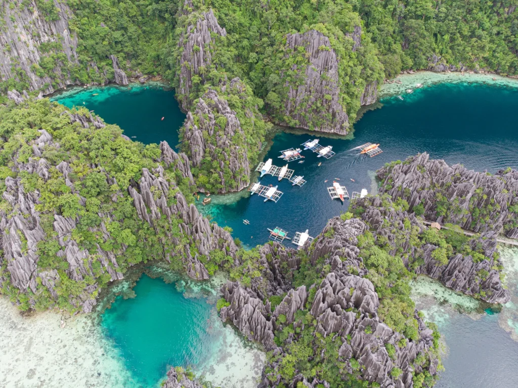 Breathtaking aerial view of turquoise waters and limestone cliffs in Coron, Philippines.